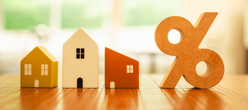 Maquette de trois maison et un % qui illustrent le prêt à taux zéro